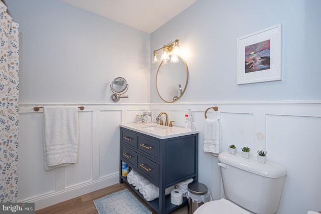 bathroom featuring hardwood / wood-style flooring, vanity, and toilet