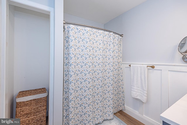 bathroom featuring walk in shower, vanity, and hardwood / wood-style floors