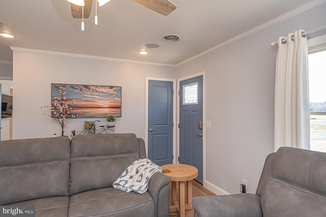 living room with crown molding, hardwood / wood-style floors, and ceiling fan