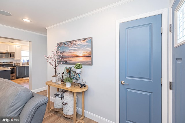 entryway with crown molding and light hardwood / wood-style flooring