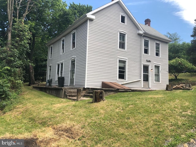 rear view of house with a yard