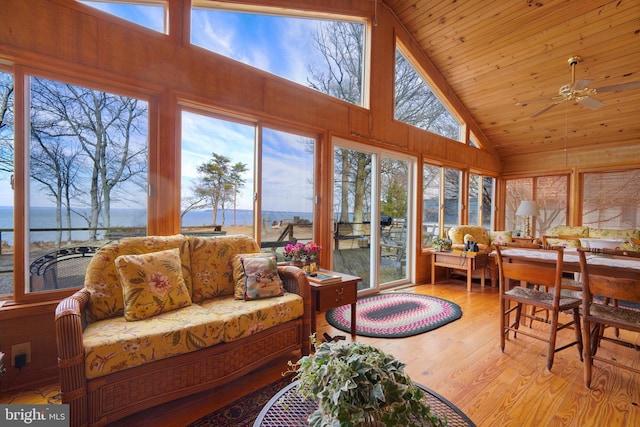 sunroom / solarium featuring vaulted ceiling, a water view, a wealth of natural light, and wood ceiling