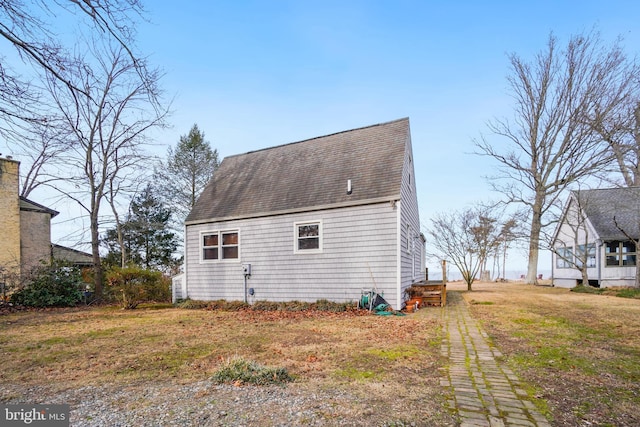 back of property with a lawn