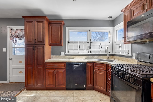 kitchen with sink, decorative light fixtures, black appliances, and light stone countertops