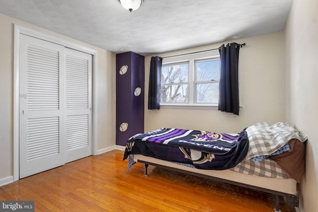 bedroom featuring hardwood / wood-style flooring and a closet