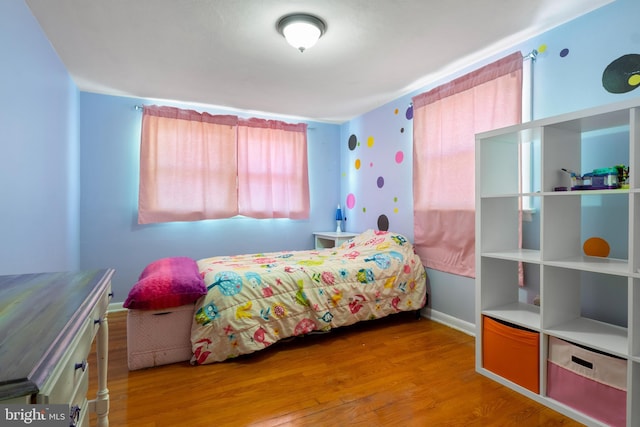 bedroom with hardwood / wood-style floors