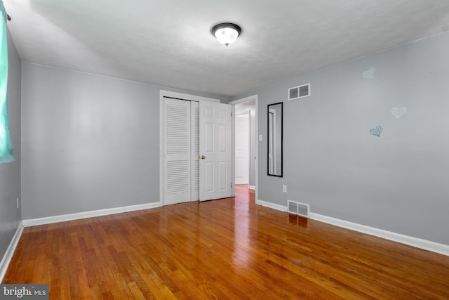 spare room with hardwood / wood-style flooring