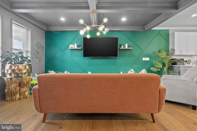 living room featuring beamed ceiling, crown molding, coffered ceiling, and an inviting chandelier