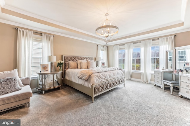 bedroom featuring a raised ceiling, carpet floors, a notable chandelier, and multiple windows