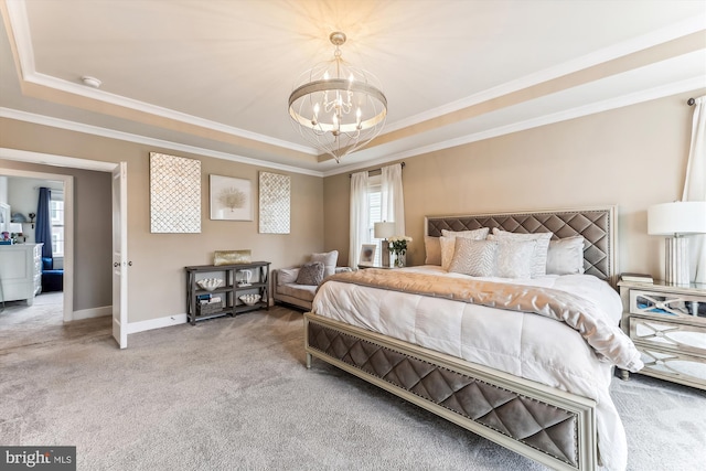 carpeted bedroom featuring ornamental molding, a raised ceiling, and a chandelier