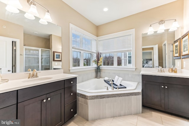 bathroom with independent shower and bath, vanity, and tile patterned floors