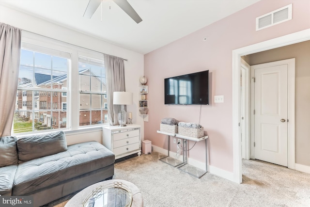 living room with light carpet, a wealth of natural light, and ceiling fan