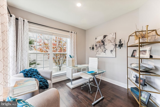 office space with a healthy amount of sunlight and dark hardwood / wood-style flooring