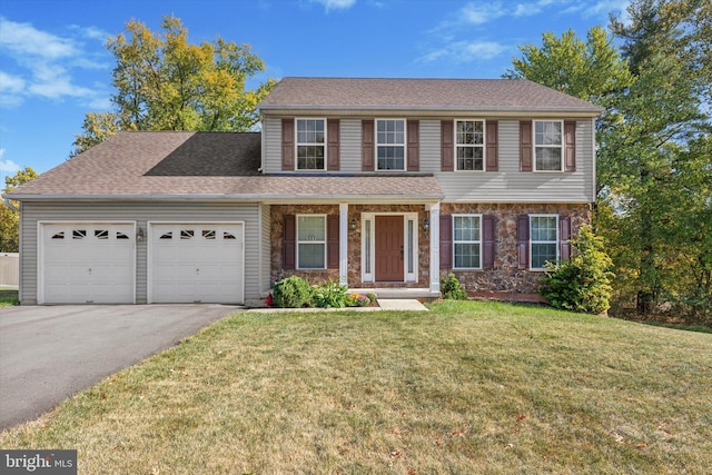 view of front of property featuring a garage and a front yard