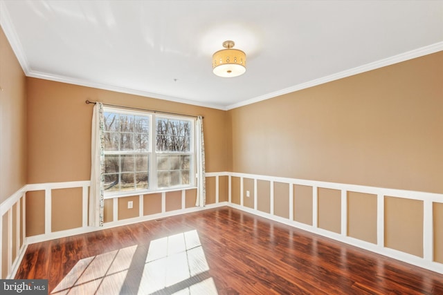 empty room featuring hardwood / wood-style flooring and crown molding