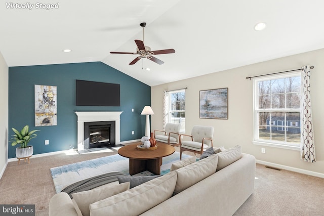 carpeted living room with lofted ceiling, a healthy amount of sunlight, and ceiling fan