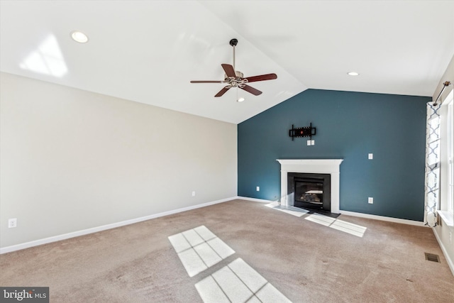 unfurnished living room featuring ceiling fan, light colored carpet, and lofted ceiling