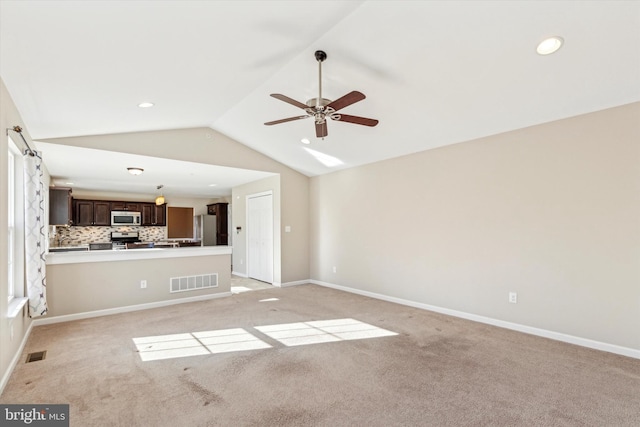 unfurnished living room featuring ceiling fan, light colored carpet, and lofted ceiling