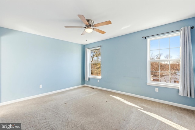 carpeted empty room featuring ceiling fan