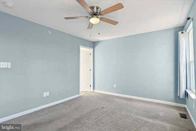 empty room featuring ceiling fan and carpet flooring