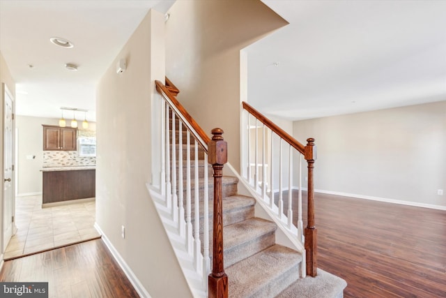 stairs featuring hardwood / wood-style floors