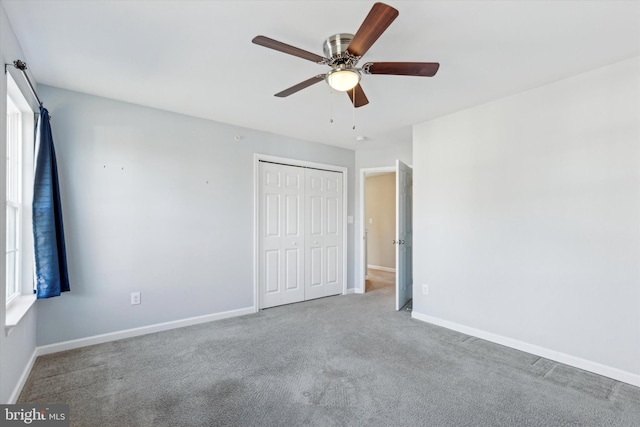 unfurnished bedroom featuring ceiling fan, a closet, and carpet