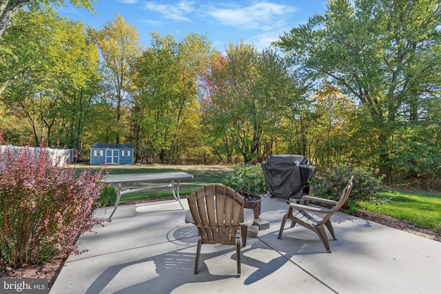 view of patio / terrace featuring grilling area and a storage unit