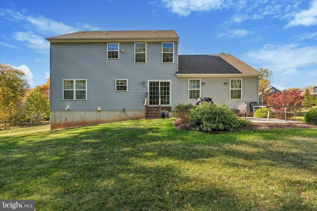 back of property with a lawn and a patio area