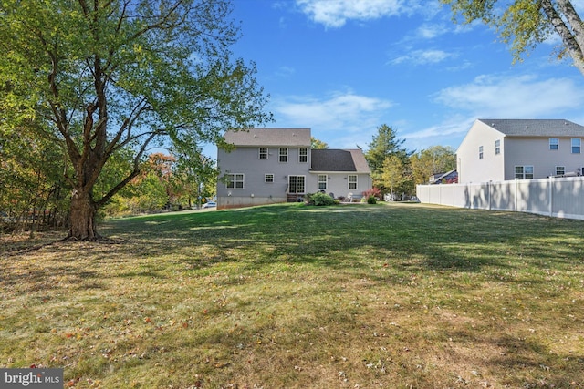 back of property featuring a lawn