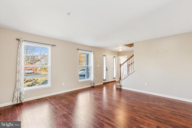 unfurnished living room featuring dark wood-type flooring