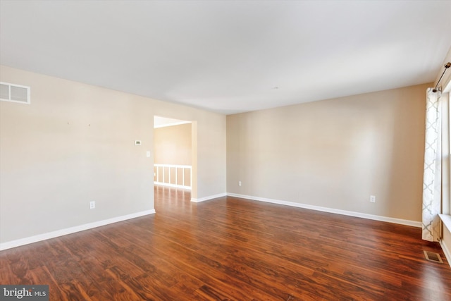 spare room with dark hardwood / wood-style floors