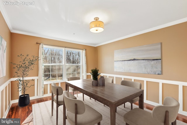 dining space featuring ornamental molding and hardwood / wood-style floors