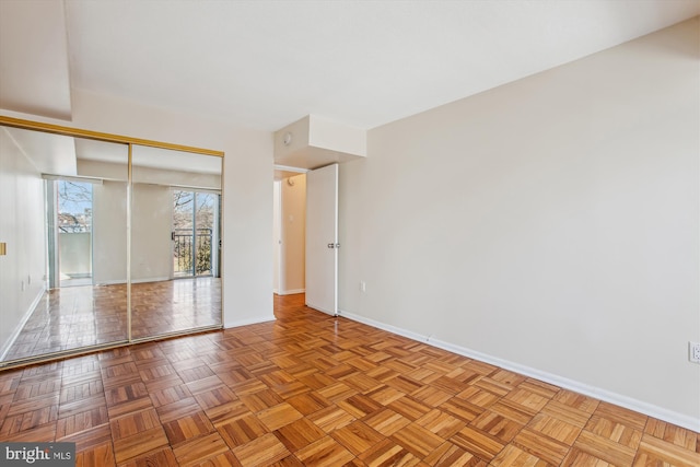 unfurnished room with light parquet flooring