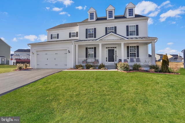 view of front facade featuring a garage, a front lawn, and covered porch