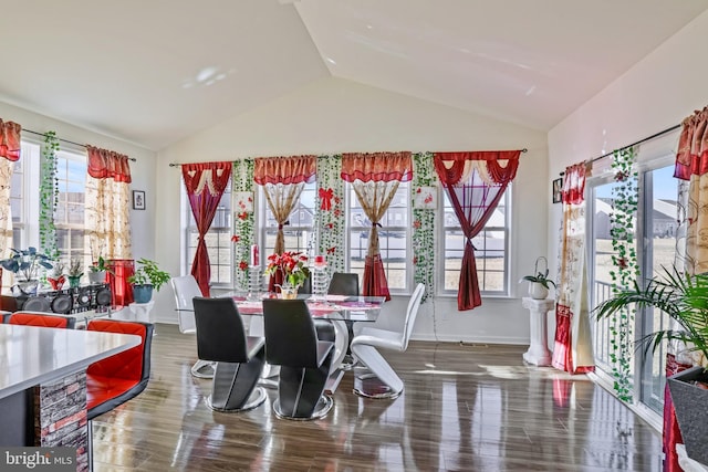 dining room featuring wood-type flooring and vaulted ceiling