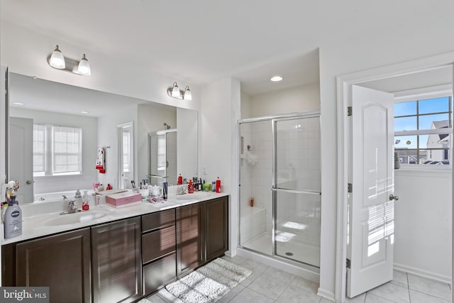 bathroom with vanity, a shower with shower door, and tile patterned floors