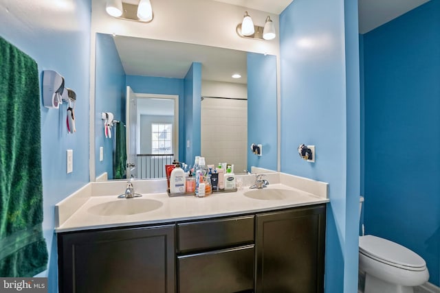 bathroom featuring vanity and toilet