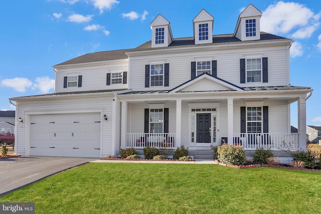 view of front of home featuring a garage, a front lawn, and a porch