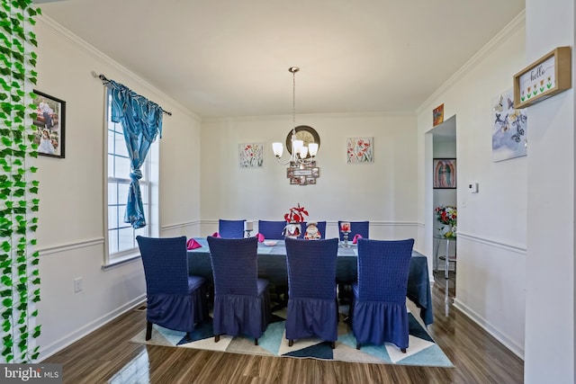 dining room with crown molding, hardwood / wood-style flooring, and a chandelier