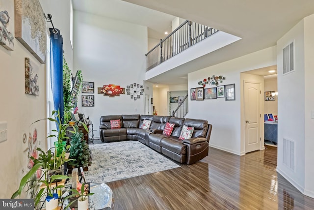 living room featuring hardwood / wood-style flooring and a high ceiling