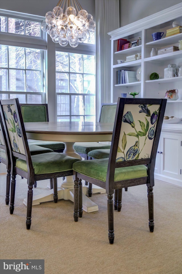 dining room with carpet, a healthy amount of sunlight, and an inviting chandelier