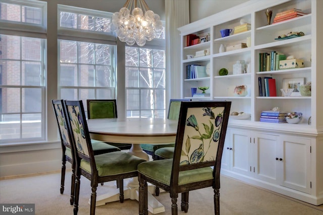 dining area with a chandelier and light carpet