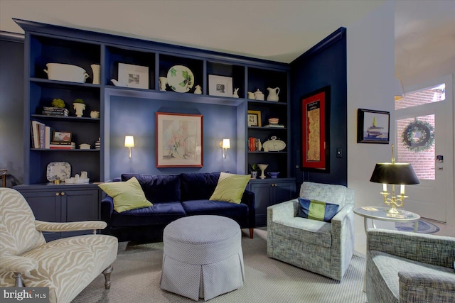 sitting room featuring carpet and built in features