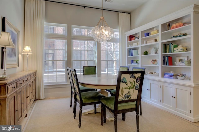 dining space with a notable chandelier, plenty of natural light, visible vents, and light colored carpet