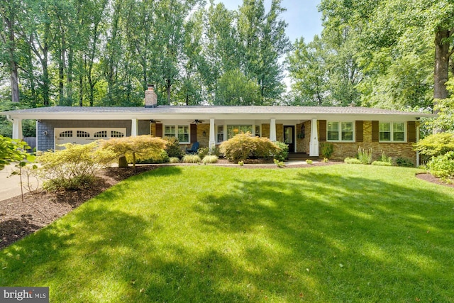 single story home featuring a garage and a front lawn