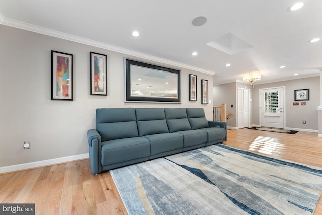 living room featuring crown molding and light hardwood / wood-style floors