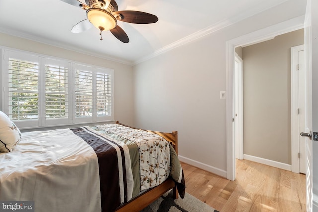 bedroom with ceiling fan, ornamental molding, and light hardwood / wood-style floors