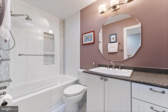 full bathroom featuring tiled shower / bath, vanity, and toilet