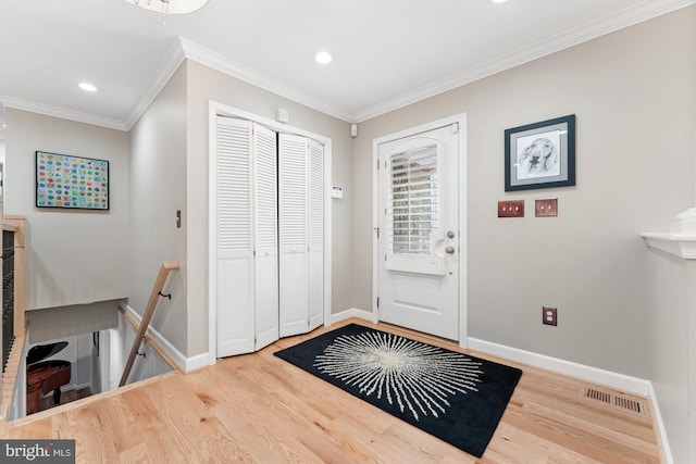 entrance foyer featuring crown molding and hardwood / wood-style floors