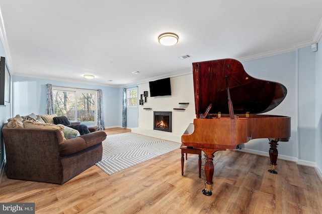 living room featuring hardwood / wood-style flooring and crown molding